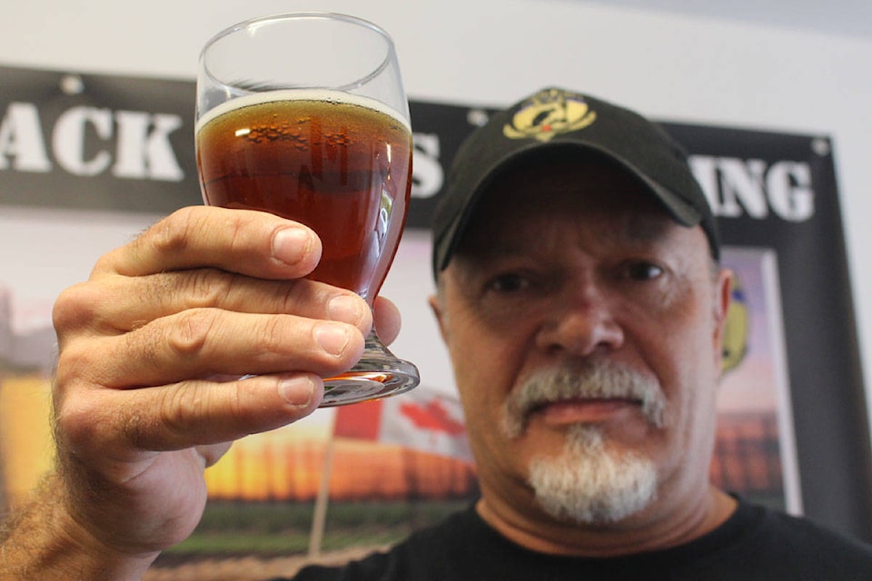 Graeme Hafey holds up a glass of V2V Black Hops Brewing’s Victory Ale. All proceeds from this non-profit go towards organizations that help veterans. (Shalu Mehta/News Staff)