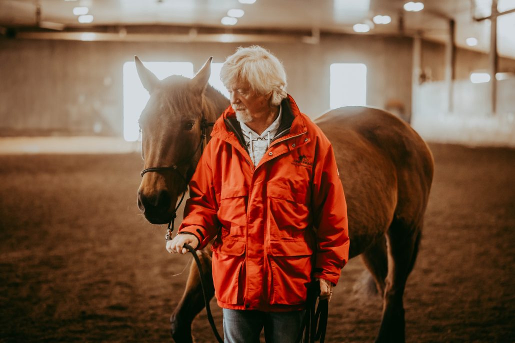 Founder Steve Critchley standing with one of the therapy horses